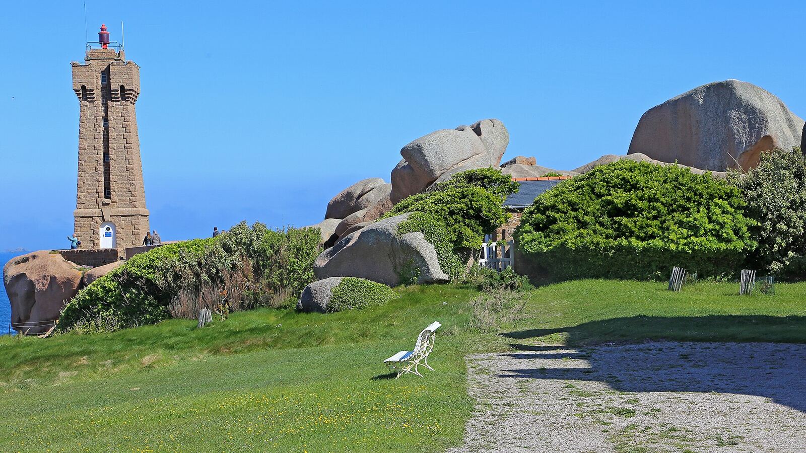 The pink granite lighthouse of Ploumanac'h among wind-carved boulders